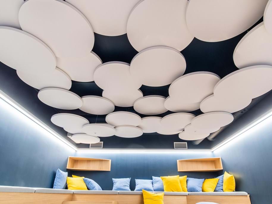 Several free-hanging acoustic panels grouped together in office socialising area