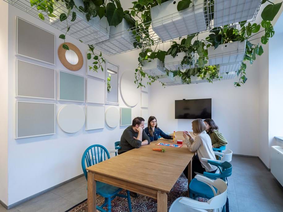 People in meeting room with square and circular wall absorbers