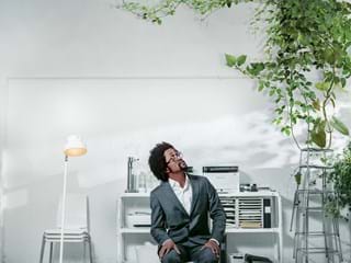 Man in office looking up at ceiling