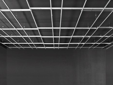Empty room with exposed ceiling suspension system