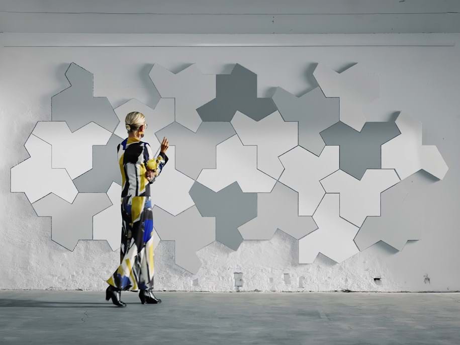 Woman looking at wall with puzzle-shaped wall absorbers