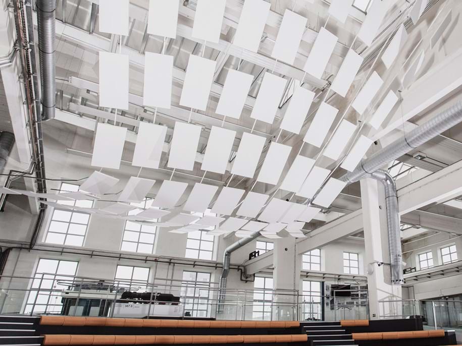 Sculptural ceiling installation with free-hanging acoustic panels in Techmania Science Center